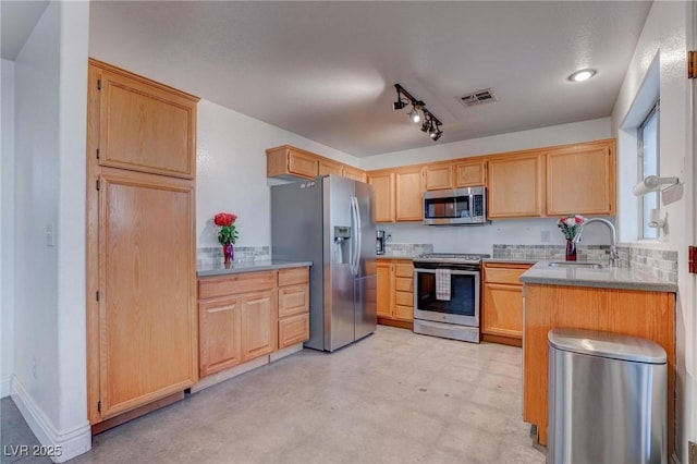 kitchen with stainless steel appliances, light brown cabinetry, a sink, and light countertops