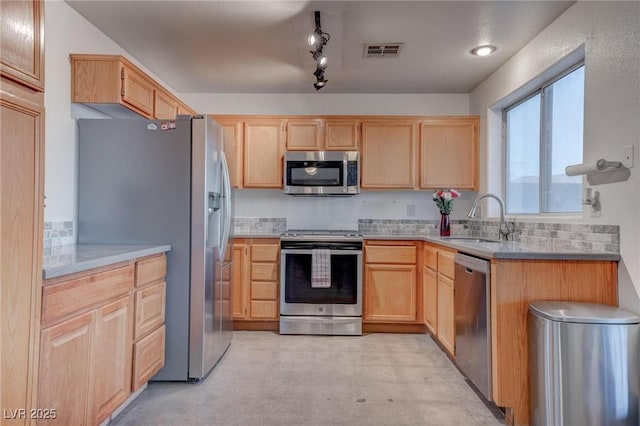 kitchen featuring light brown cabinets, a sink, visible vents, light countertops, and appliances with stainless steel finishes