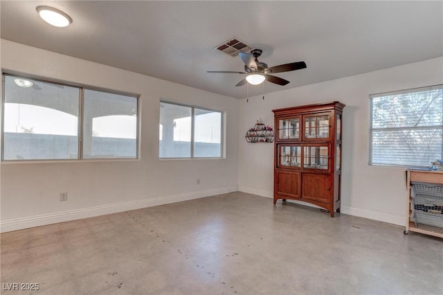 spare room featuring ceiling fan and a healthy amount of sunlight