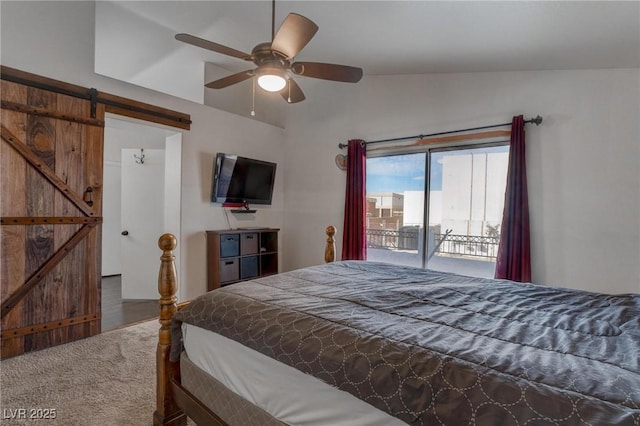 carpeted bedroom with vaulted ceiling, a barn door, access to outside, and ceiling fan