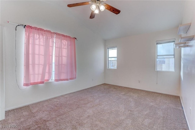 carpeted spare room with ceiling fan and lofted ceiling