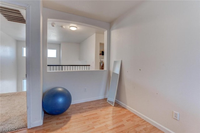 exercise room with hardwood / wood-style floors