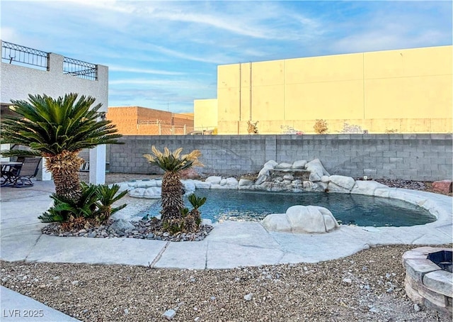 view of pool featuring a patio area and fence