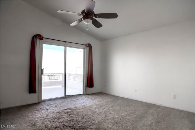 carpeted spare room with vaulted ceiling and a ceiling fan