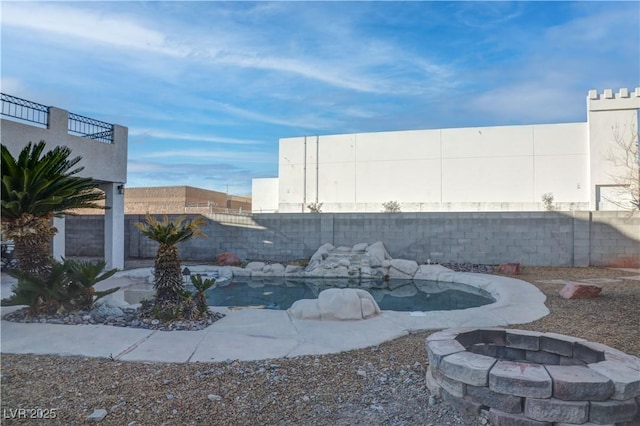 view of patio / terrace featuring a fenced backyard and a fire pit