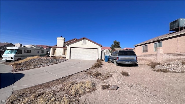 exterior space with a garage and central AC unit