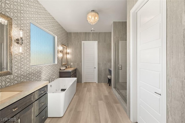 bathroom with vanity, separate shower and tub, hardwood / wood-style floors, and a chandelier