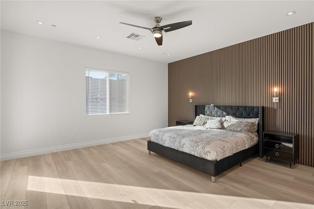 bedroom with ceiling fan and light wood-type flooring