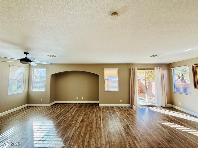 unfurnished room with ceiling fan, hardwood / wood-style floors, and a textured ceiling