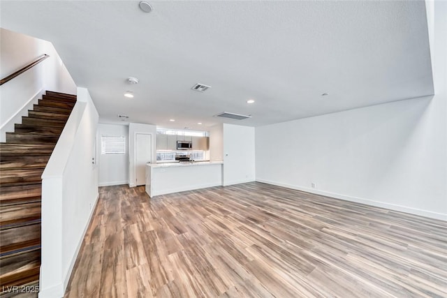 unfurnished living room featuring light hardwood / wood-style floors