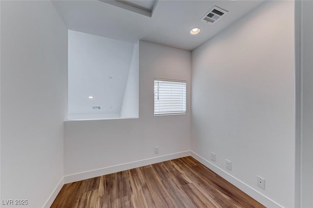 unfurnished room with hardwood / wood-style flooring