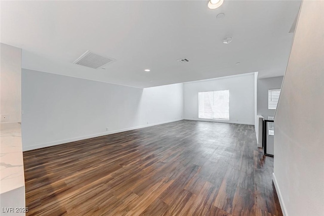 unfurnished room featuring dark wood-type flooring