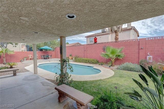 view of swimming pool with a yard and a patio area