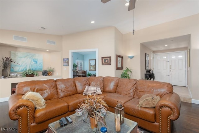 living room with hardwood / wood-style flooring, lofted ceiling, and ceiling fan