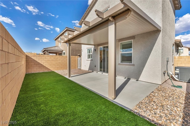 back of house featuring a yard, a patio, and central air condition unit