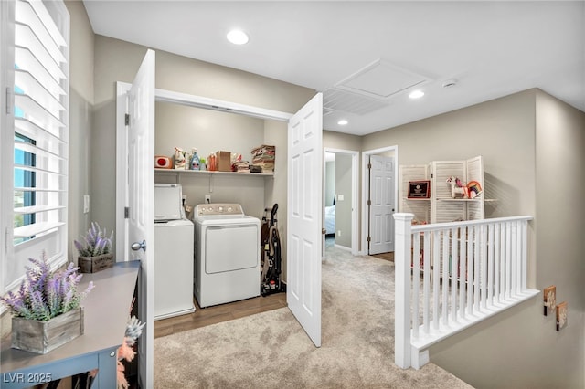 clothes washing area featuring washer and dryer and light carpet