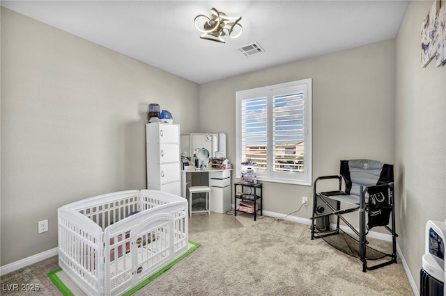 carpeted bedroom featuring a crib