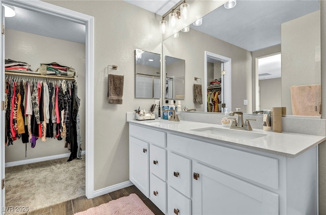 bathroom with vanity and wood-type flooring