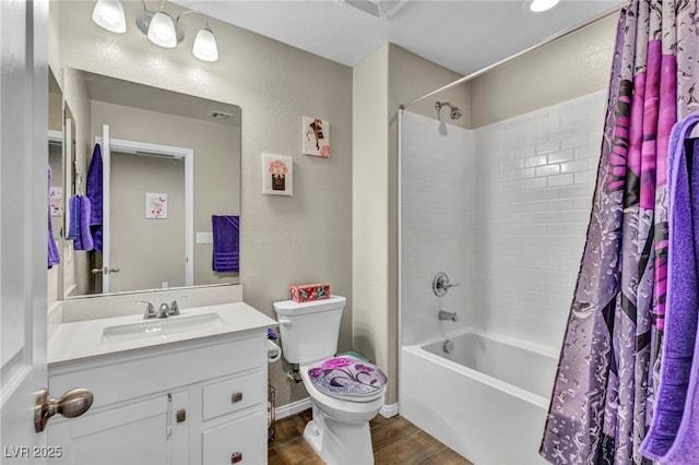 full bathroom with shower / tub combo with curtain, vanity, toilet, and hardwood / wood-style floors