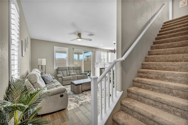 living room featuring sink and ceiling fan