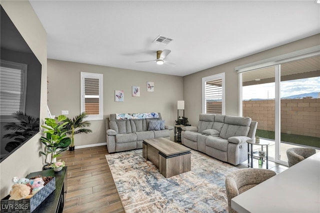 living room with dark hardwood / wood-style floors and ceiling fan