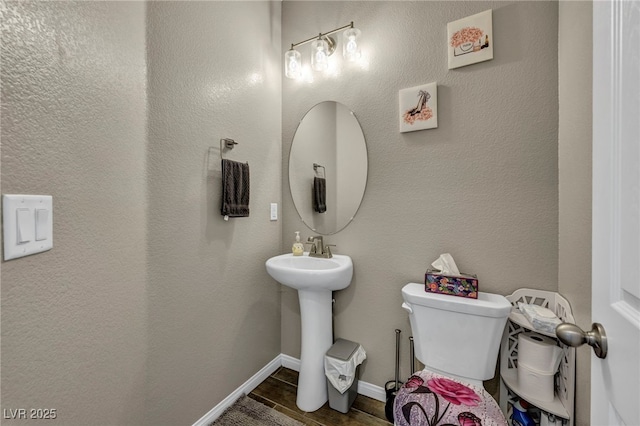 bathroom with sink, toilet, and hardwood / wood-style floors