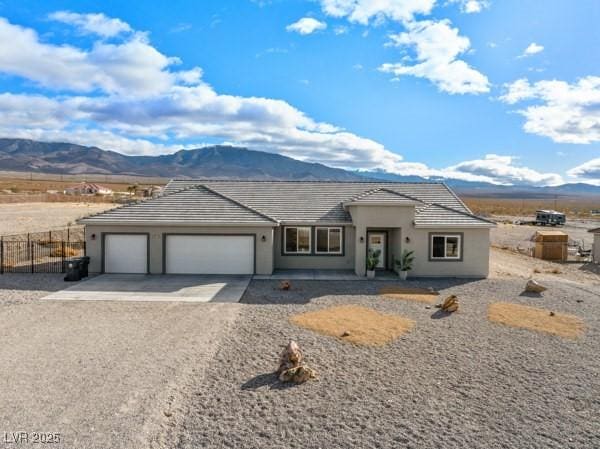 view of front of house with a garage and a mountain view