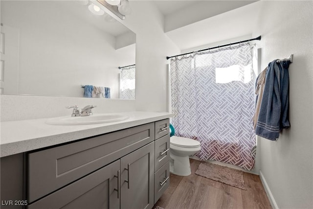 bathroom featuring vanity, hardwood / wood-style floors, a shower with shower curtain, and toilet