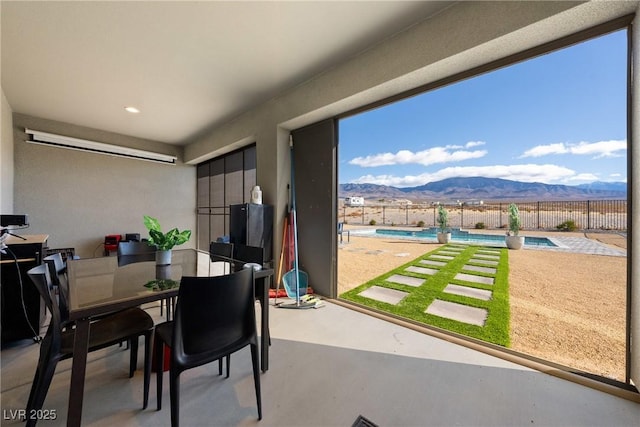 view of patio featuring a fenced in pool and a mountain view