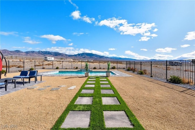 exterior space with a fenced in pool, a mountain view, and a patio area