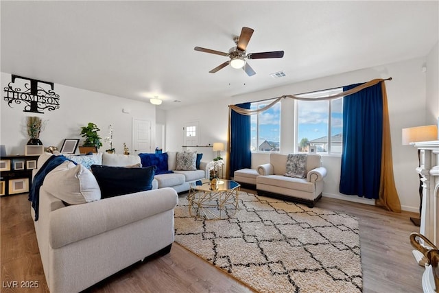 living room featuring hardwood / wood-style floors, a wealth of natural light, and ceiling fan