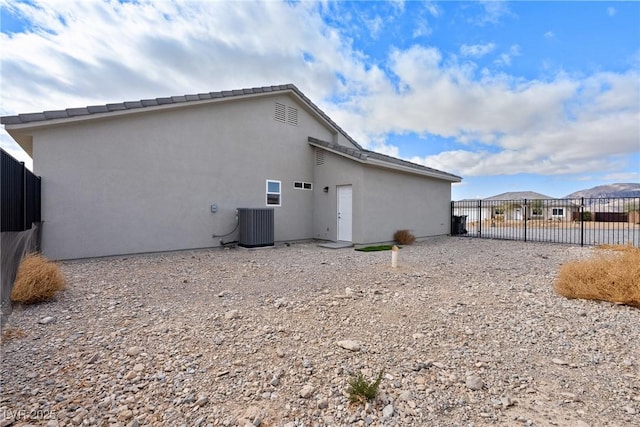 rear view of house featuring central air condition unit