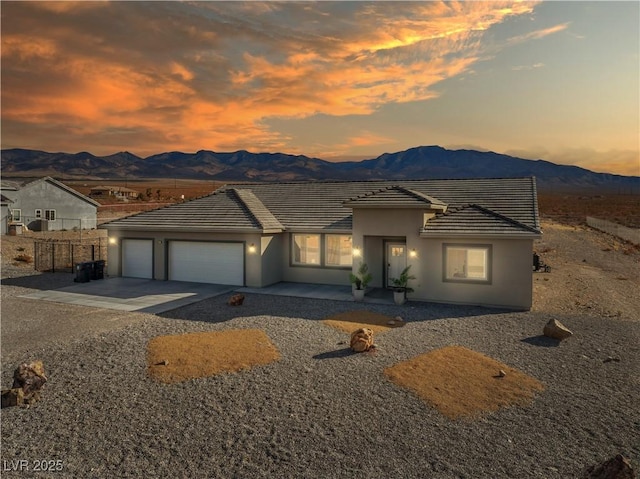 view of front of house with a garage and a mountain view