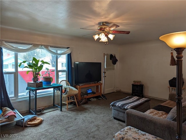 carpeted living room with ceiling fan