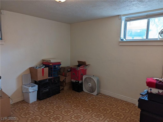 playroom with a textured ceiling