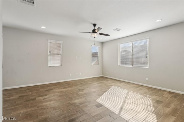 empty room with hardwood / wood-style flooring and ceiling fan