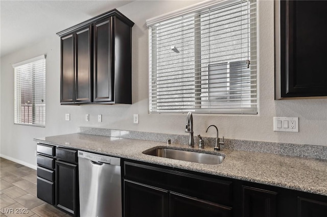 kitchen featuring sink, light stone countertops, and dishwasher