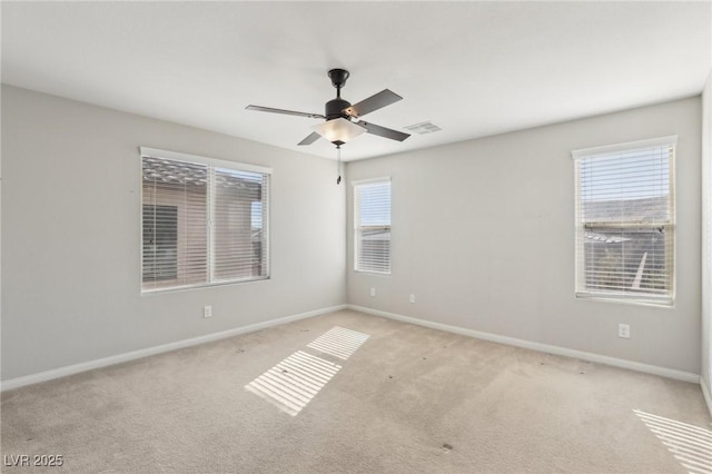 unfurnished room featuring light carpet, plenty of natural light, and ceiling fan