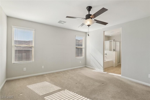 interior space with light colored carpet and ceiling fan