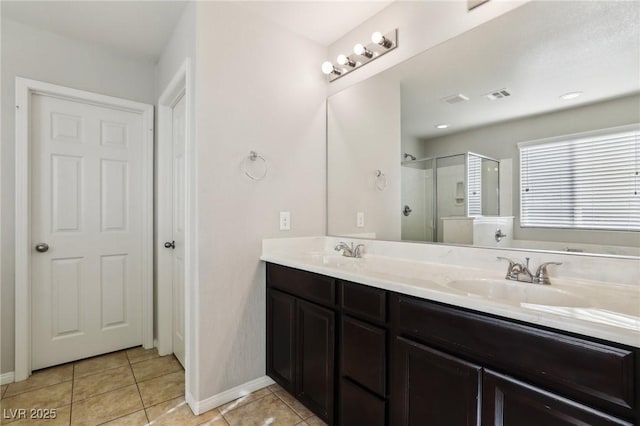 bathroom with vanity, a shower with shower door, and tile patterned flooring