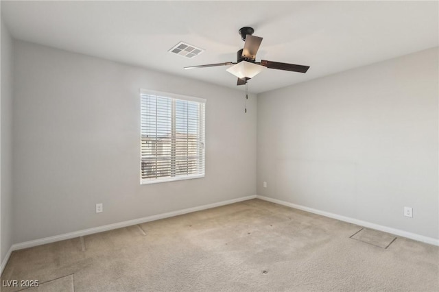 carpeted spare room with ceiling fan