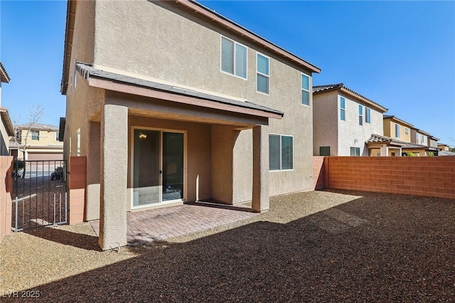 back of house with a patio area