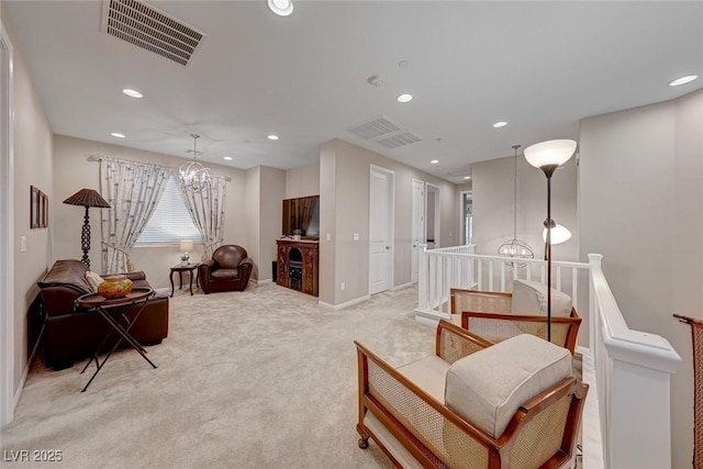 living area with light colored carpet and a chandelier