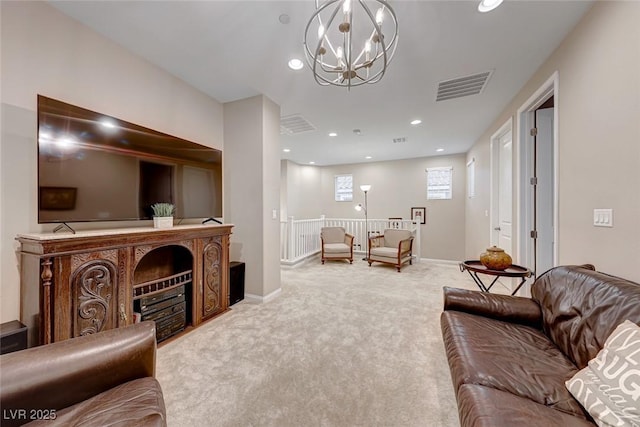 carpeted living room with a chandelier