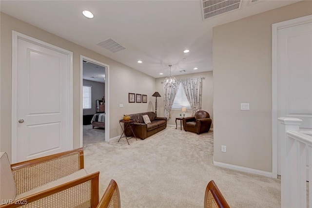 living room with carpet floors and a chandelier