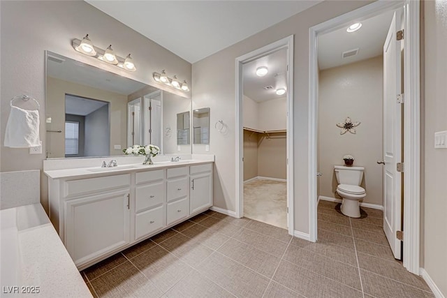 bathroom with tile patterned floors, vanity, and toilet