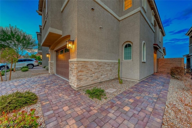 property exterior at dusk with a garage