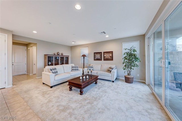 living room featuring plenty of natural light and light colored carpet