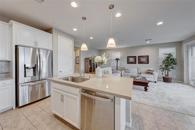 kitchen featuring sink, decorative light fixtures, white cabinets, and appliances with stainless steel finishes