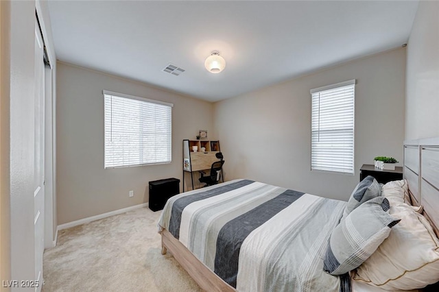 carpeted bedroom featuring multiple windows